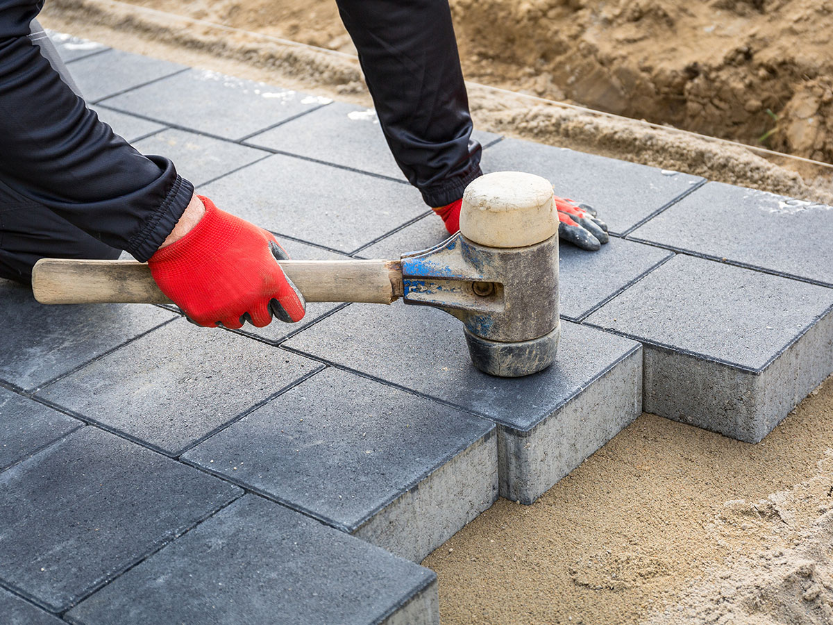 Image of a man installing pavers